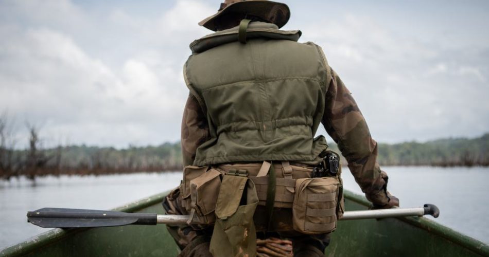 two hunters are duck hunting in a boat. What is the safest position?